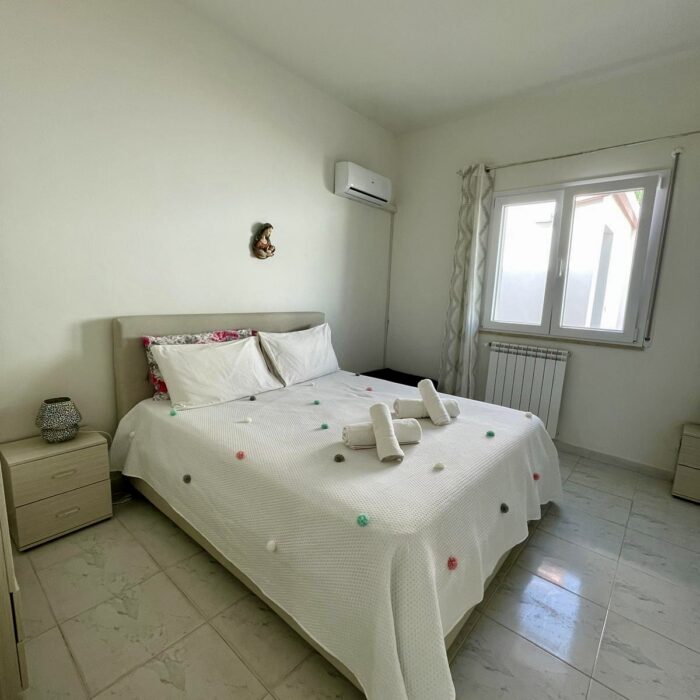 Bedroom with bed, window and night table