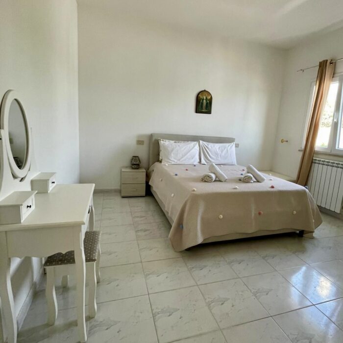 Bedroom with bed, window and night table