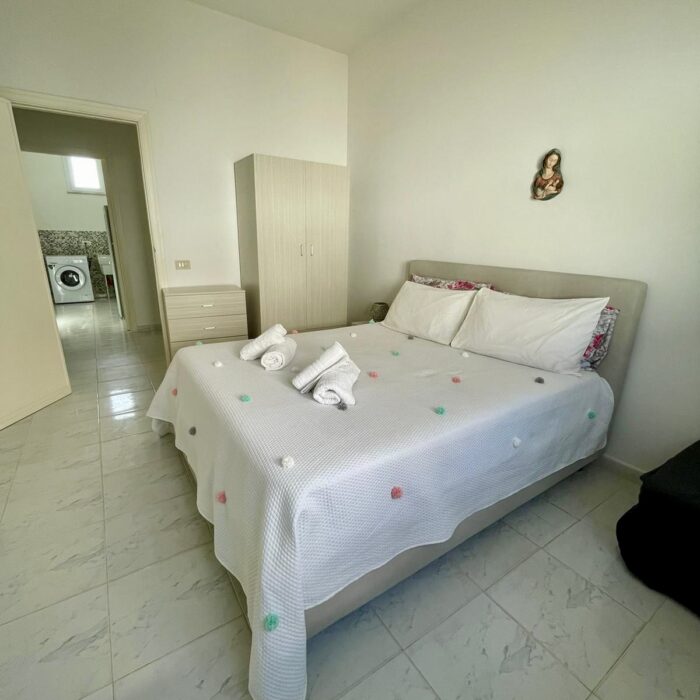 Bedroom with bed, wardrobe and night table